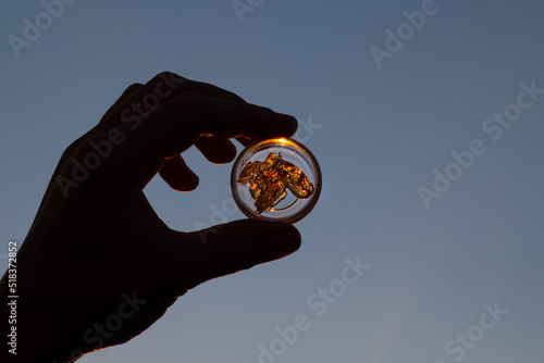 cannabis wax with high thc in hand on sky background.