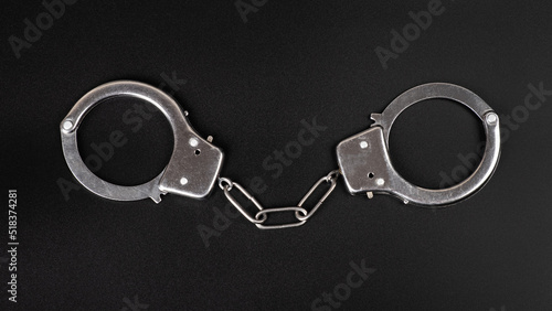 handcuffs on black background, concept arrest.
