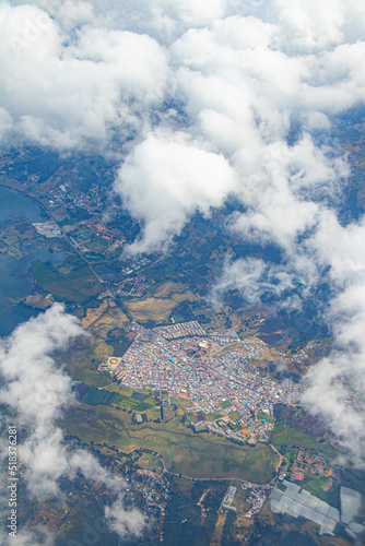 landscape of clouds, houses and mountains from the sky © Johanna