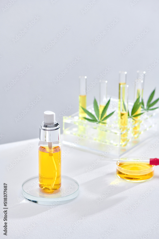 Test tubes with urine samples and hemp leaves on table Test tubes with urine samples and hemp leaves on table
