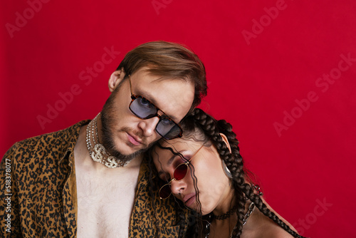 Sensual trendy woman embracing with boyfriend in studio photo