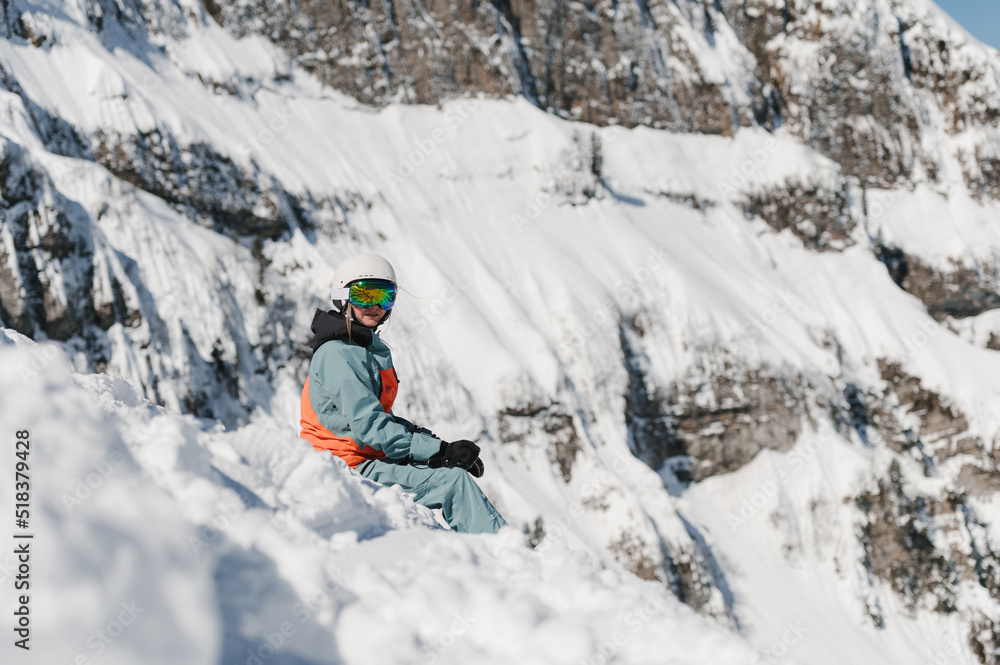 Young lady resting on snowdrift in mountainous valley Young lady resting on snowdrift in mountainous valley