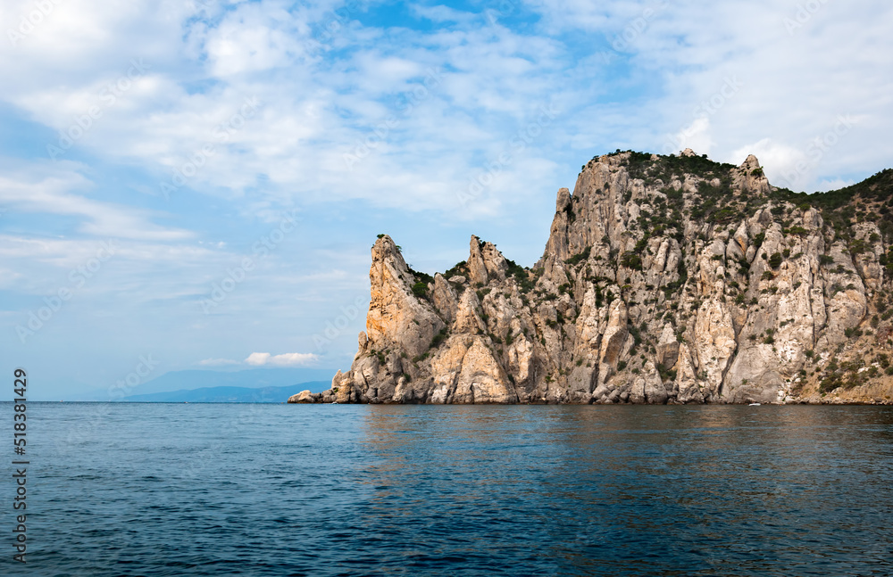 Mountain range jutting out into the sea. Mountain cliff in the Black Sea.