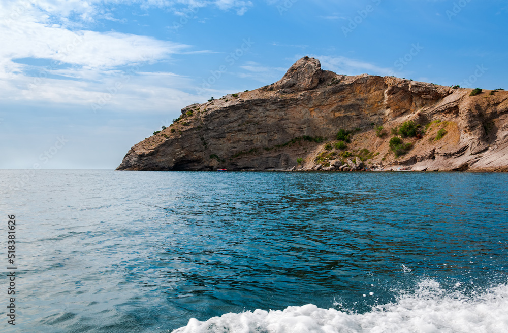 Mountain range jutting out into the sea. Mountain cliff in the Black Sea. Mountain range jutting out into the sea. Mountain cliff in the Black Sea.