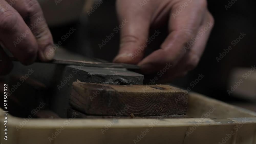 Master swordsmith is sharpening knife on grindstone with water Master swordsmith is sharpening knife on grindstone with water