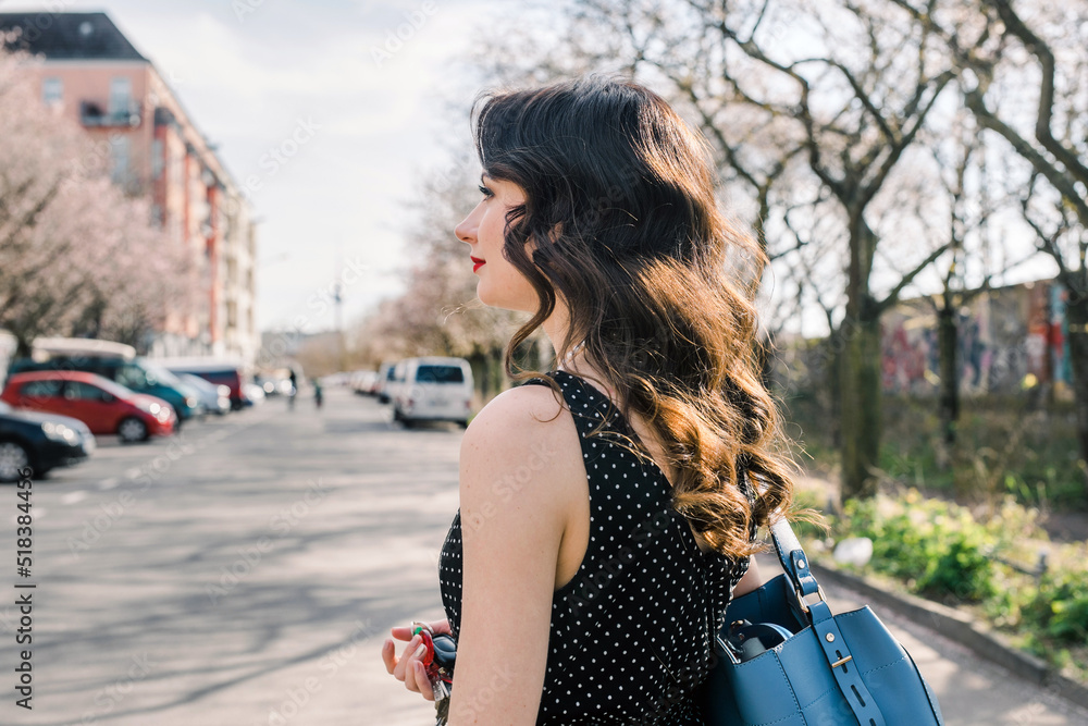 Classically beautiful woman with wavy hair outside on a spring day Classically beautiful woman with wavy hair outside on a spring day