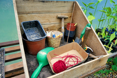 Home made wooden potting box containing items for used in gardening
 photo