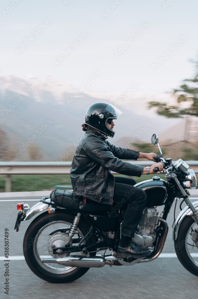 Man driving motorcycle near mountains Man driving motorcycle near mountains