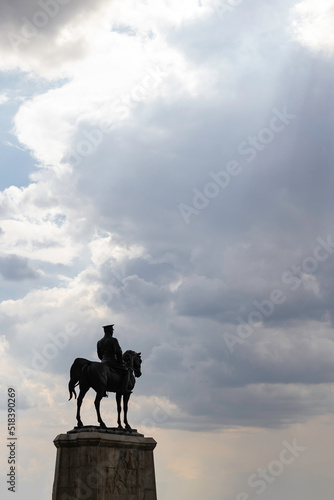 Silhouette of monument of Ataturk with cloudy sky and sunrays between the clouds © senerdagasan