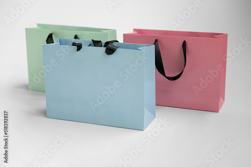 Mock-up of blank craft package, mockup of colored paper shopping bag with black handles on the white background