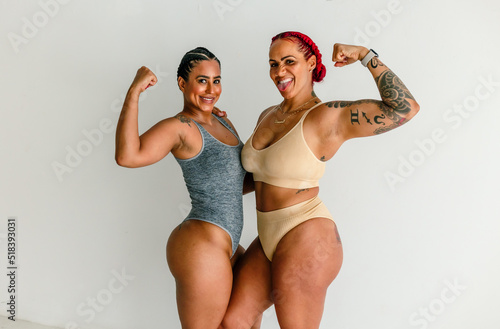 Athletic women flexing muscles