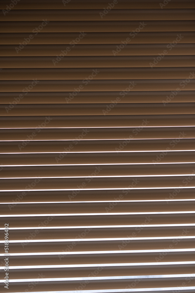 Blinds. The light outside the window shines through the blinds Blinds. The light outside the window shines through the blinds