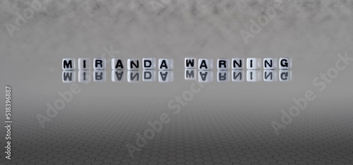 miranda warning word or concept represented by black and white letter cubes on a grey horizon background stretching to infinity photo