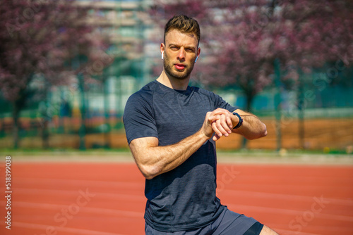 A sports white man who checks his heart rate on a smart watch after training outdoors © DusanJelicic