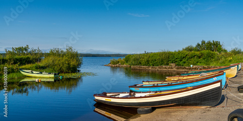 warm evening light at Lough Melvin light with colorful wooden fishing boats in the foreground