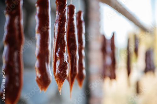 Freshly made homemade churchkhela in Georgia is hung on a stick to cook, harden and be ready to eat. Incredibly tasty