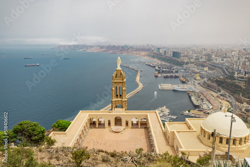 Panoramic view of blessed virgin mary church from Santa Cruz fortress, one of the three forts in Oran, the second largest port of Algeria; Summer day, looking from high above towards the city. photo