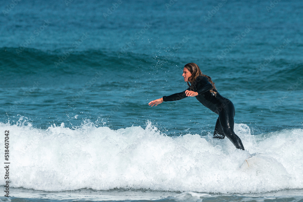 Positive woman with surfboard surfing waves Positive woman with surfboard surfing waves