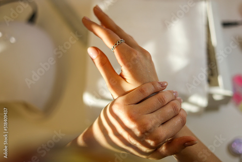 Close-up of a finished basic beige manicure with sunburst and shine photo