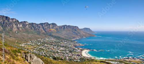 Fototapeta Naklejka Na Ścianę i Meble -  Landscape mountain panorama, sea and coastal city with residential buildings in famous travel or tourism destination. Copy space and scenic Twelve Apostles with blue sky in Cape Town, South Africa