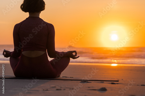 Woman meditating at the nature in the morning and practicing yoga