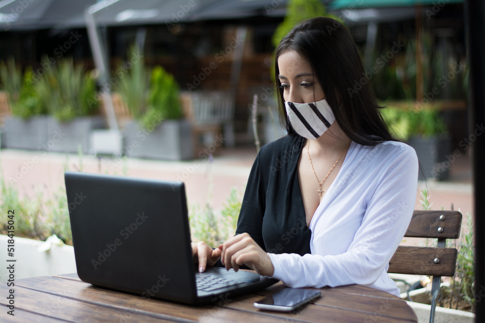 Young woman working outdoor wearing mask Young woman working outdoor wearing mask