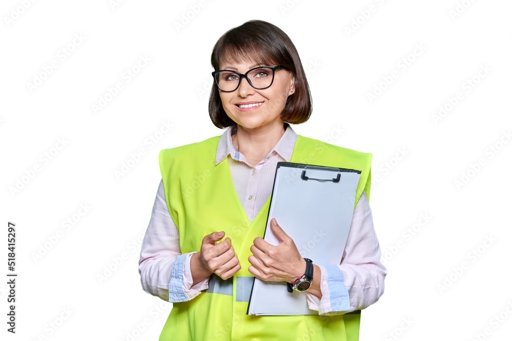 Woman in safety vest with clipboard looking at camera, white isolated background Woman in safety vest with clipboard looking at camera, white isolated background