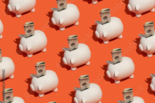 Piggy banks with a hundred dollar cash bill. Savings concept.