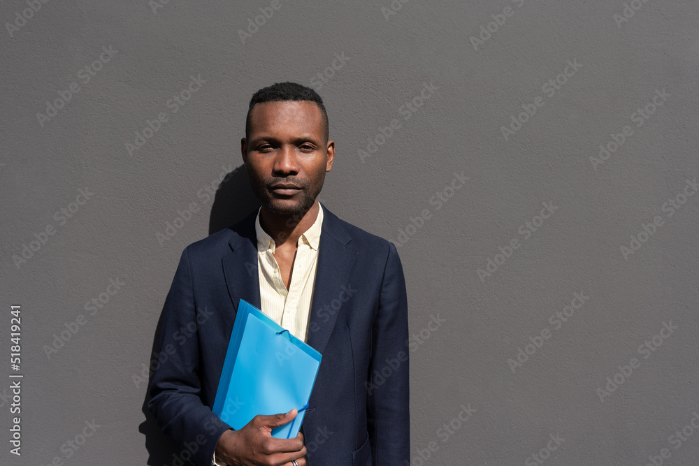 Portrait Of Man Holding Folder Outdoors Portrait Of Man Holding Folder Outdoors