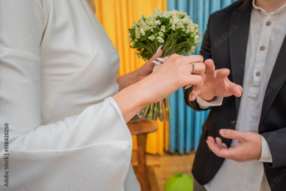 Obraz premium brides and grooms exchange rings at a wedding. Wedding ceremony
