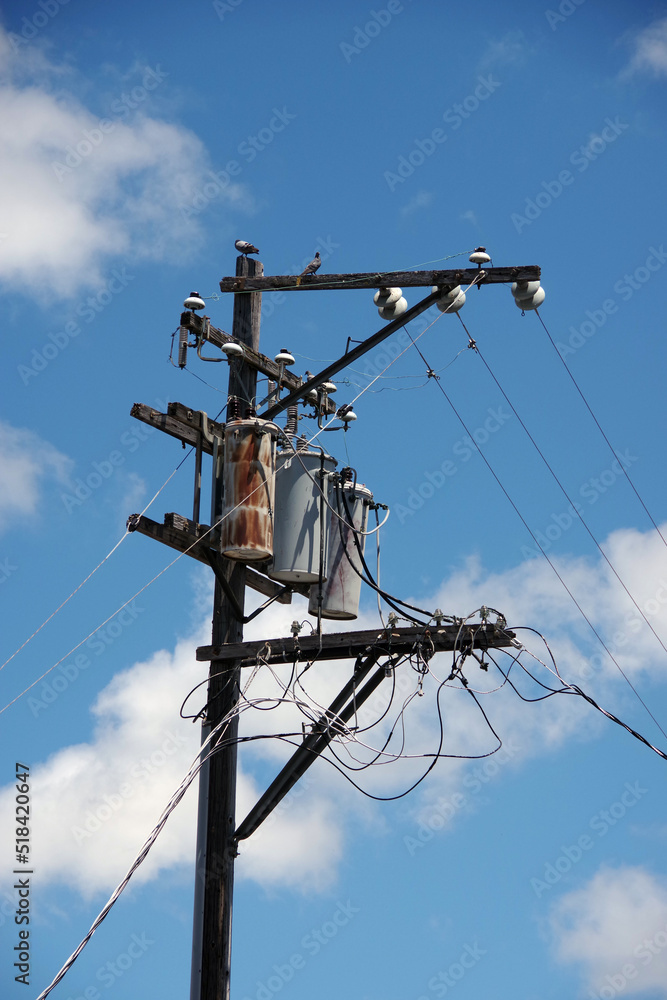Electricity distribution pylon with power lines under blue sky Electricity distribution pylon with power lines under blue sky