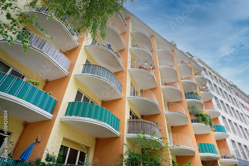 Slika na platnu many semicircular balconies on a colorful residential building from the middle o