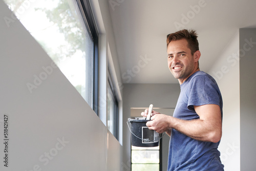 Man holding bucket of paint photo
