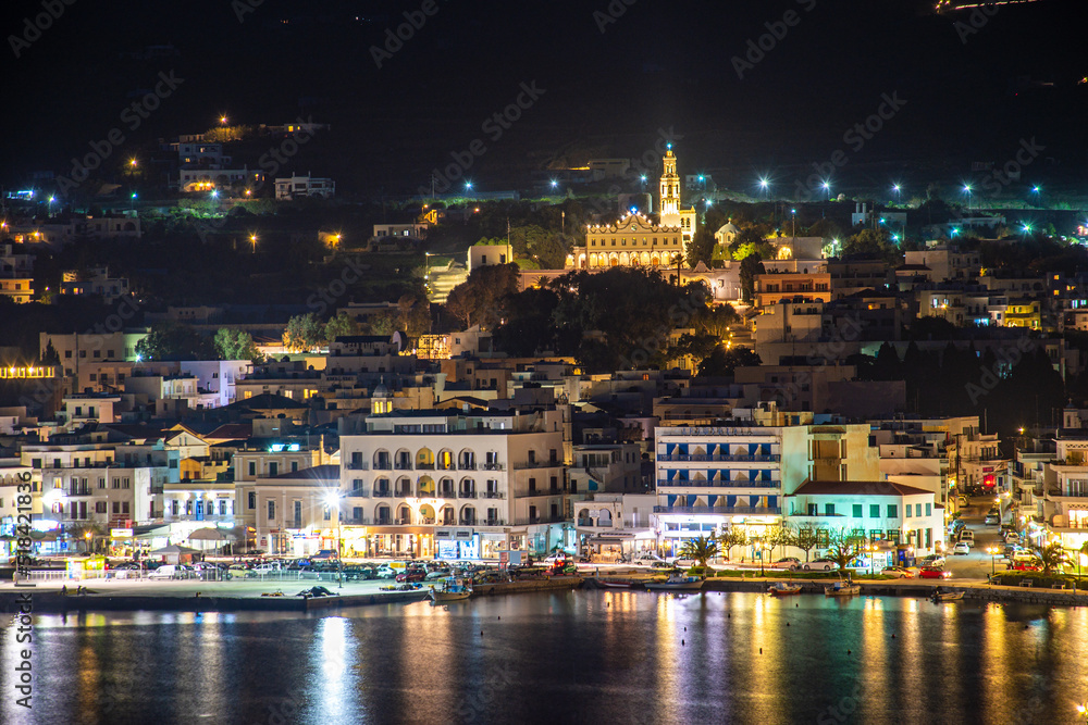 Night long exposure view of Tinos town. Centered the famous church of Panagia, Virgin Mary, illuminated at night. Tinos island Cyclades, Greece.