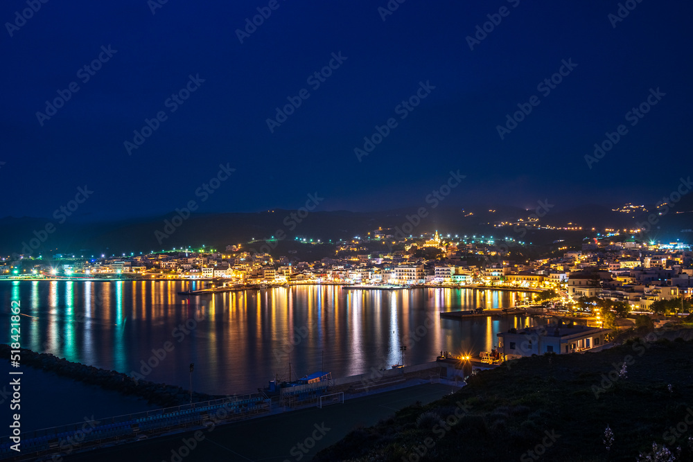 Night long exposure view of Tinos town. Centered the famous church of Panagia, Virgin Mary, illuminated at night. Tinos island Cyclades, Greece. Night long exposure view of Tinos town. Centered the famous church of Panagia, Virgin Mary, illuminated at night. Tinos island Cyclades, Greece.