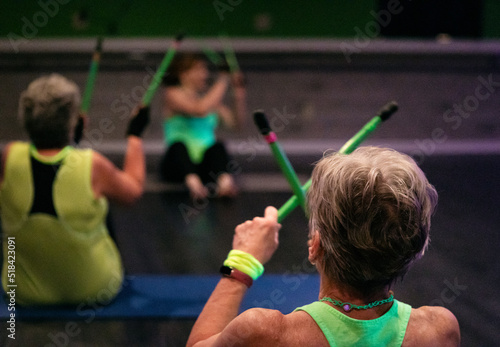 Rear View Of Women Doing Drumming Workout