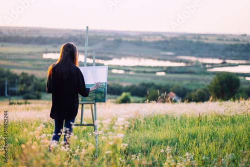 landscape painter woman at summer sunset photo