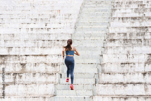 Women are exercising and jogging up the stairs.