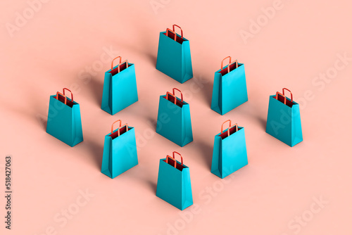 rhombus of blue shopping bags in different positions on pink bac photo