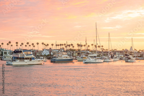 Yachts on the dock in the port against the backdrop of sunset on the ocean. California. Newport Beach
