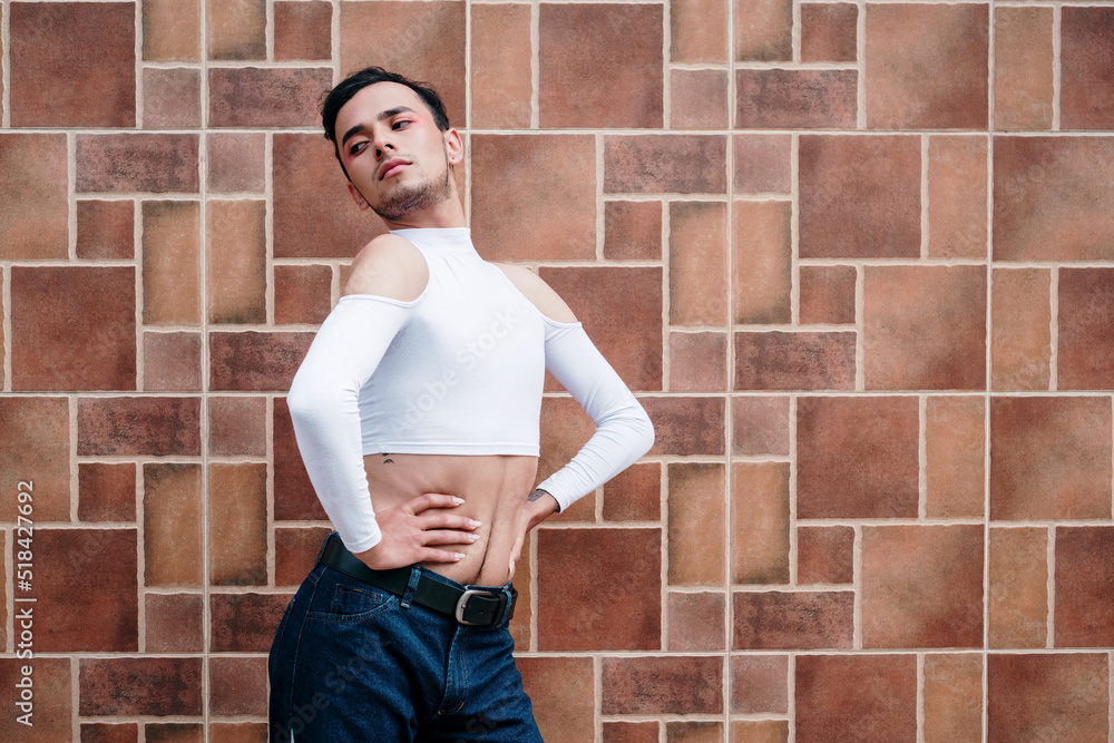 Sexy posture of a young homosexual man on a geometric wall Sexy posture of a young homosexual man on a geometric wall