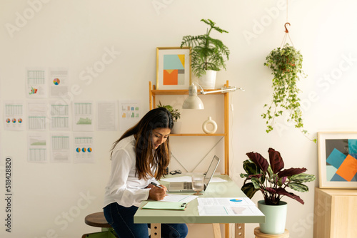 Young business woman working at charming office photo