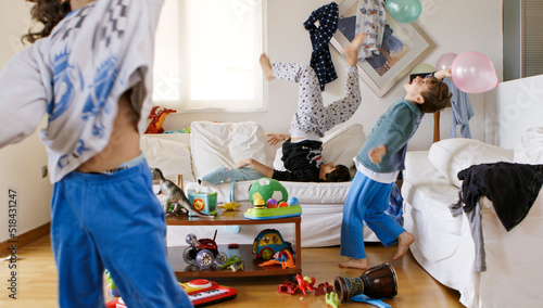 Kids playing with balloons in the living room photo