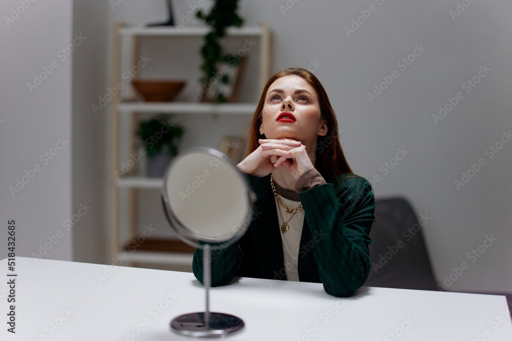 Stunning red-haired girl in front of the mirror in the room Stunning red-haired girl in front of the mirror in the room