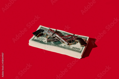 toy guns and fake dollar banknotes photo