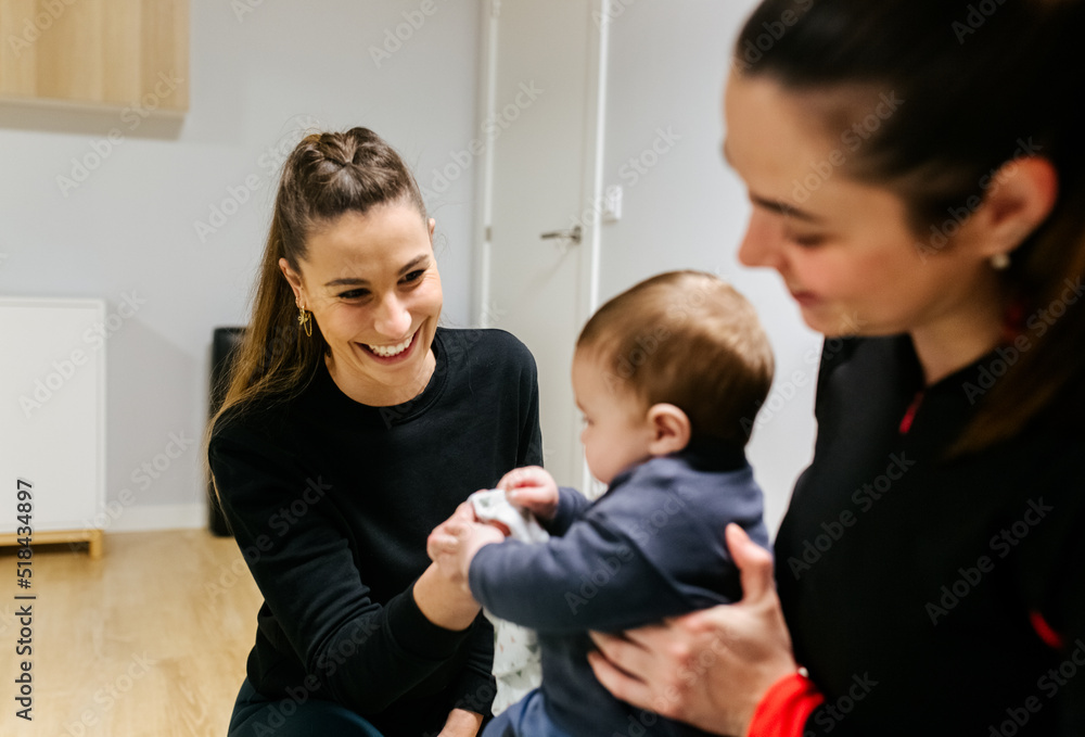 Mother and baby attending a postpartum recovery class Mother and baby attending a postpartum recovery class