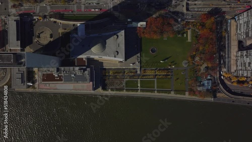 Aerial birds eye overhead top down view of UN headquarters buildings on East River waterfront. Autumn colour trees and busy road. Manhattan, New York City, USA