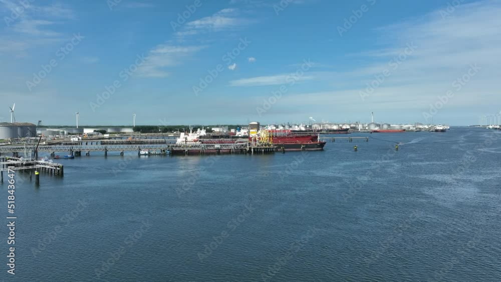 Crude Oil Tanker Ships Unloading Petrochemicals to a Shore Fuel Depot Crude Oil Tanker Ships Unloading Petrochemicals to a Shore Fuel Depot
