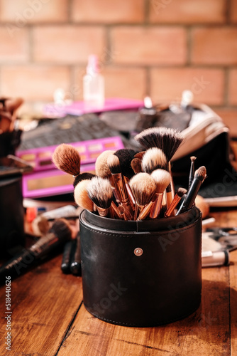 Case with makeup brushes on a table photo