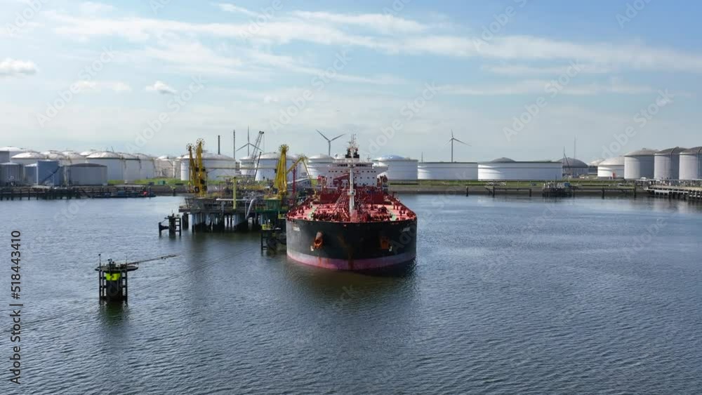 Crude Oil Liquid Cargo Transporter Ship Unloading Petrochemicals to a Fuel Depot Crude Oil Liquid Cargo Transporter Ship Unloading Petrochemicals to a Fuel Depot